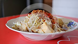Kupat Tahu is a traditional Indonesian food made from ketupat, fried tofu, and savory sweet soy sauce.