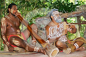 Aborigine actors perform music with traditional instruments in the Tjapukai Culture Park in Kuranda, Queensland, Australia.