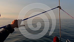 Kuril whale watching cruise ship passenger looking at humback whale near mountains with binoculars and camera exploring