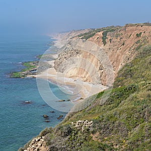 Kurkar sandstone cliff facing the Mediterranean seashore, Israel photo