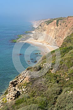 Kurkar sandstone cliff facing the Mediterranean seashore, Israel photo