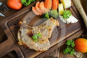 Kurobuta pork chop steak on wooden table