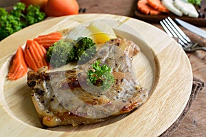 Kurobuta pork chop steak on wooden table