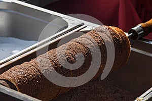 Kurtos kalacs or chimney cakes, preparing on charcoal grill, street food traditional Hungarian