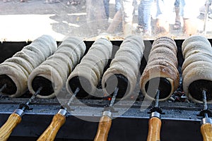 Kurtos kalacs or chimney cakes, preparing cooking on charcoal grill