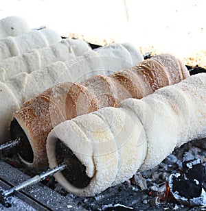 Kurtos kalacs or chimney cakes, preparing cooking on charcoal grill