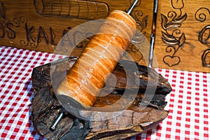 Kurtos kalacs or chimney cakes, preparing cooking on charcoal grill, street food Hungarian