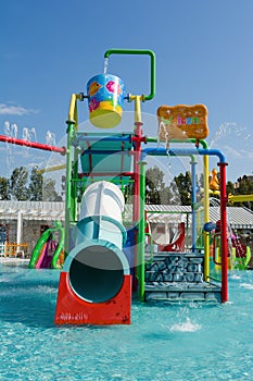 KUSADASI, TURKEY - AUGUST 21, 2017: Colourful plastic slides in aquapark. Children water playground