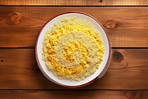 Kuskus corn porridge on a wooden table, top view