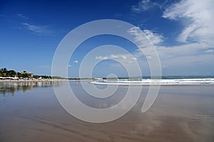 Kuta beach bali wet sand reflecting sky photo
