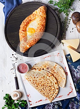 Kutaby and Adjara khachapuri hachapuri with eggs in still life, top view