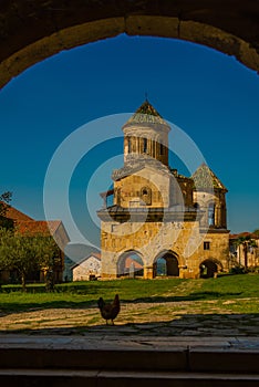 KUTAISI, GEORGIA: View of the old stone Bell Tower in the Orthodox monastery of Gelati on a sunny summer day. UNESCO.