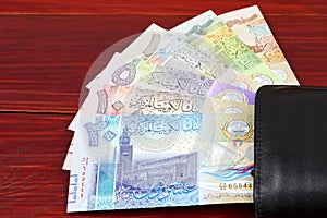 Kuwaiti Dinar in the black wallet