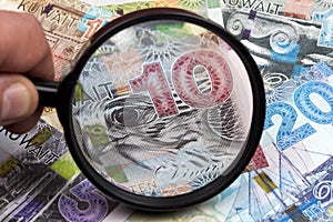 Kuwaiti dinar in a magnifying glass
