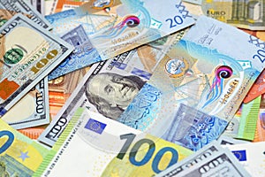 Kuwaiti dinar money with American dollars bills and European euros banknotes, selective focus of a pile of 20 twenty Kuwaiti