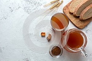 Kvass in a glass and a jug on a light background