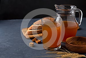 Kvass in a glass and a jug of rye bread