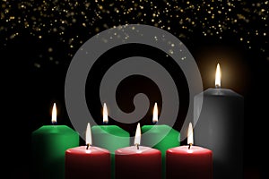 Kwanzaa holiday background with candle light of seven candle sticks in black, green, red symbolising 7 principles of African