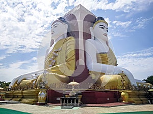 Kyaikpun pagoda against blue sky, Four Seated Buddha shrine at Kyaikpun Pagoda in Bago, Burma