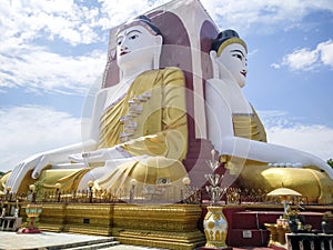 Kyaikpun pagoda against blue sky, Four Seated Buddha shrine at Kyaikpun Pagoda in Bago, Burma