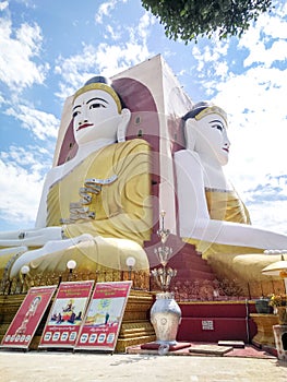 Kyaikpun pagoda against blue sky, Four Seated Buddha shrine at Kyaikpun Pagoda in Bago, Burma