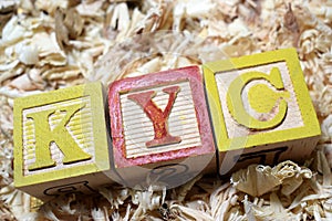 KYC Know Your Customer acronym on wooden blocks photo