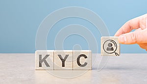 KYC Know Your Customer on wooden cubes. Business verifying the identity of its clients concept. Financial client authentication.