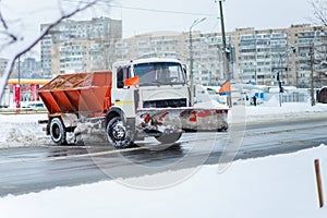 Kyiv, Ukraine-25.12.17: Snow plow clears roads in the city after heavy winter snowfall blizzard for vehicle access. Big orange car