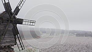 Kyiv, Ukraine. Captivating wooden windmill within snowy wasteland