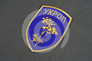 KYIV, UKRAINE - July, 16, 2015. Ukraine Army unofficial uniform badge UKROP on camouflaged uniform