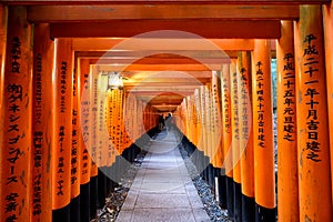 Kyoto, Japan - Nov 11 2017 : Pathway with red ancient wood torii gate and japanese letter at Fushimi Inari