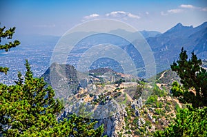 Kyrenia Girne mountain range from medieval Saint Hilarion Castle with green trees and rocks