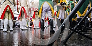KÃ¶ln Karneval - Group of fine  men in carneval uniforms in white red, green and yellow from behind with white pants on stage outs