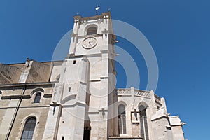 L`Isle-sur-la-Sorgue city view of the facade and clock tower of the main catholic church Notre Dame des Anges france