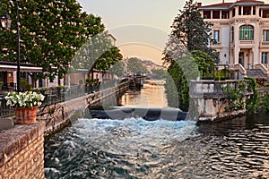 L`Isle-sur-la-Sorgue, Vaucluse, Provence-Alpes-Cote d`Azur, France: landscape at dawn of the city surrounded by water canals