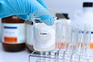 L-Lysine powder in chemical container , chemical in the laboratory and industry