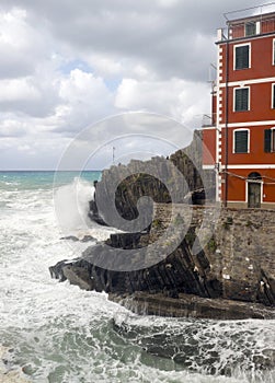 L Riomaggiorre Cinque Terre old building raging stormy sea cli