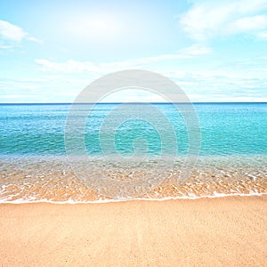 Sandy beach with calm water against blue skies. photo