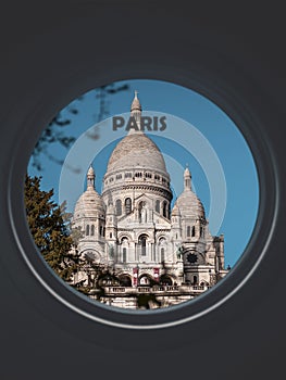 La Basilique Sacre Coeur seen through a circular window labeled Paris