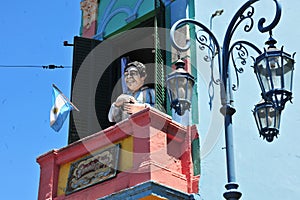 Caminito is a colorful area in La Boca in Buenos Aires. With colorfully sculture figure building at balcony whit h maradona