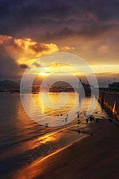 La bola beach in Getxo at sunset photo