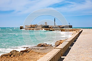 La Caleta Beach, Balneario de la Palma Building and Castle of San Sebastian at sunset - Cadiz, Andalusia, Spain photo