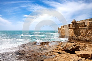 La Caleta Beach, Balneario de la Palma Building and Castle of San Sebastian at sunset - Cadiz, Andalusia, Spain photo