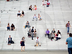 La Defense, Paris,, France, August 20 2018: people sitting and walking on the stairs of the Grand Arch