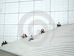 La Defense, Paris,, France, August 20 2018: people sitting and walking on the stairs of the Grand Arch