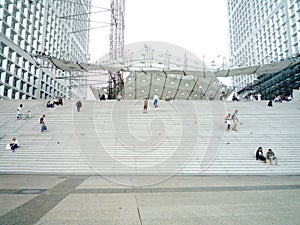 La Defense, Paris,, France, August 20 2018: people sitting and walking on the stairs of the Grand Arch