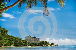 La Digue Island, Seychelles island. World famous tropical beach Anse Source d`Argent. Shape of palm leaves and ocean