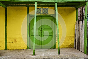 La Entrade, Ecuador - September 14, 2018 - green door on yellow wall. photo