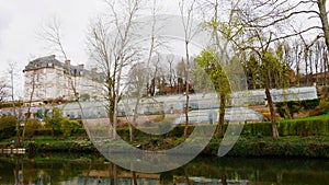 The La Folie de Buissy castle and its tropical greenhouse in the town of Long on the banks of the Somme river