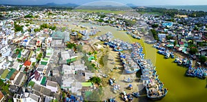La Gi fishing village seen from above with hundreds of boats anchored along both sides of river